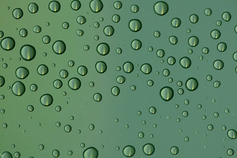 Water droplets on green glass