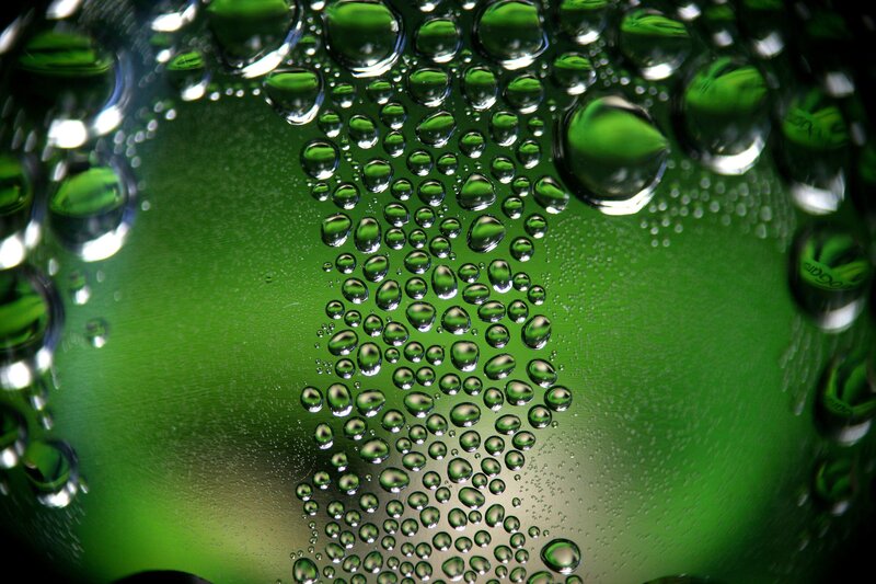Water droplets on green glass