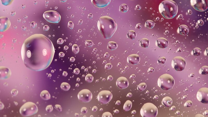 Water droplets on purple glass