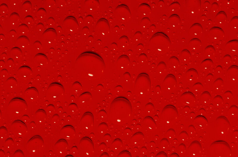 Water droplets on red surface