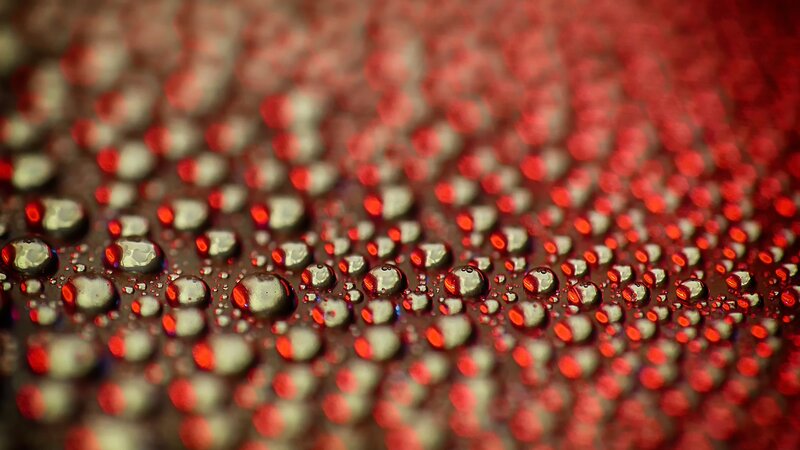 Water Droplets on Red Surface — Dramatic