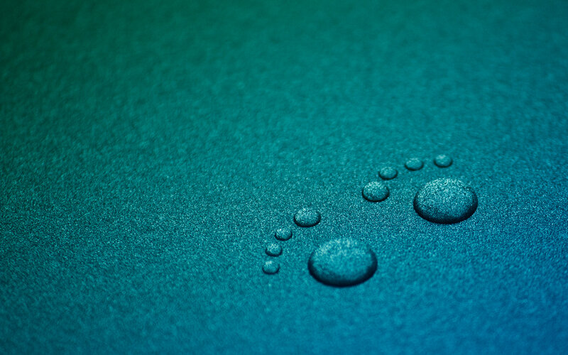 Water droplets on teal surface