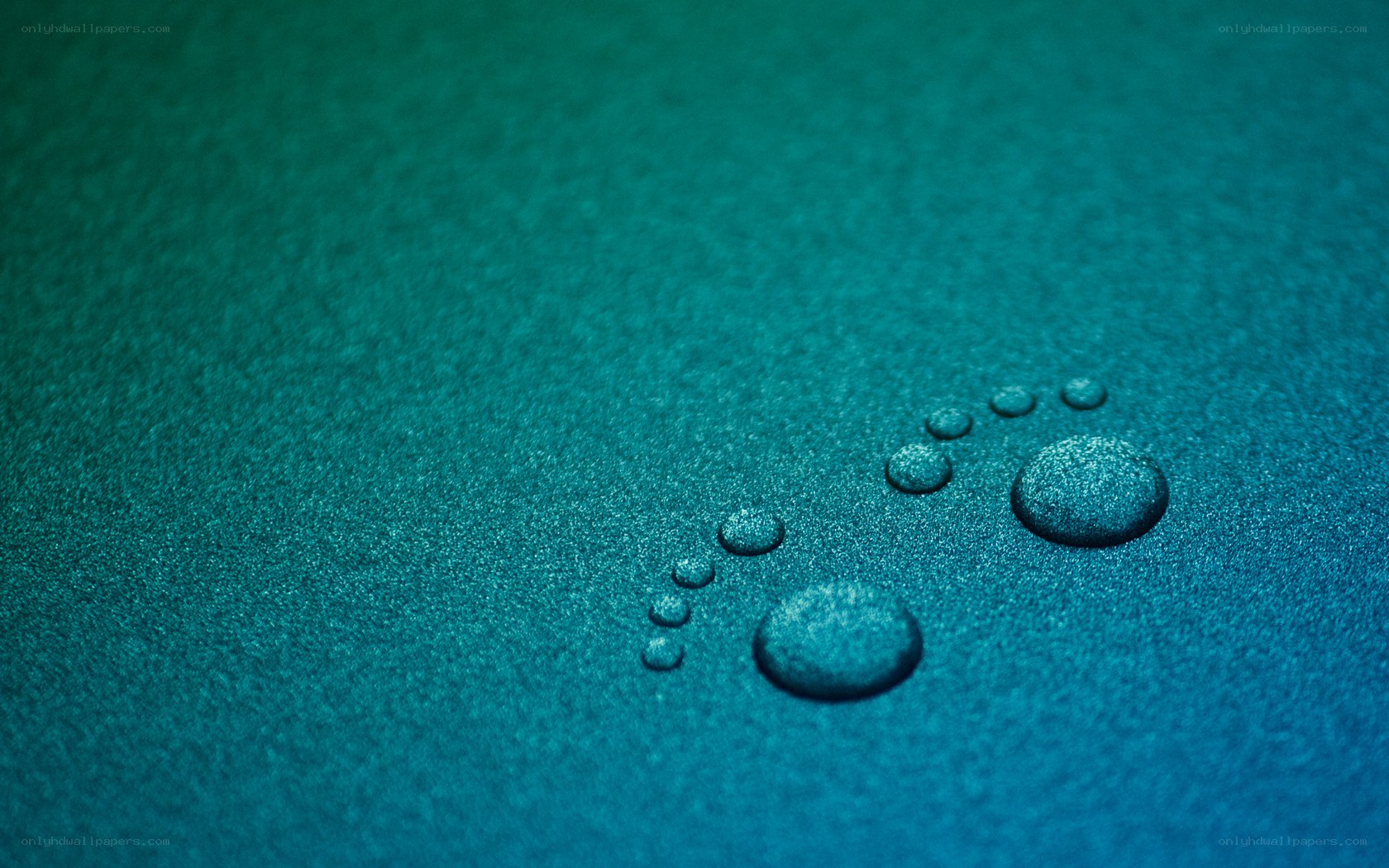 Water droplets on teal surface