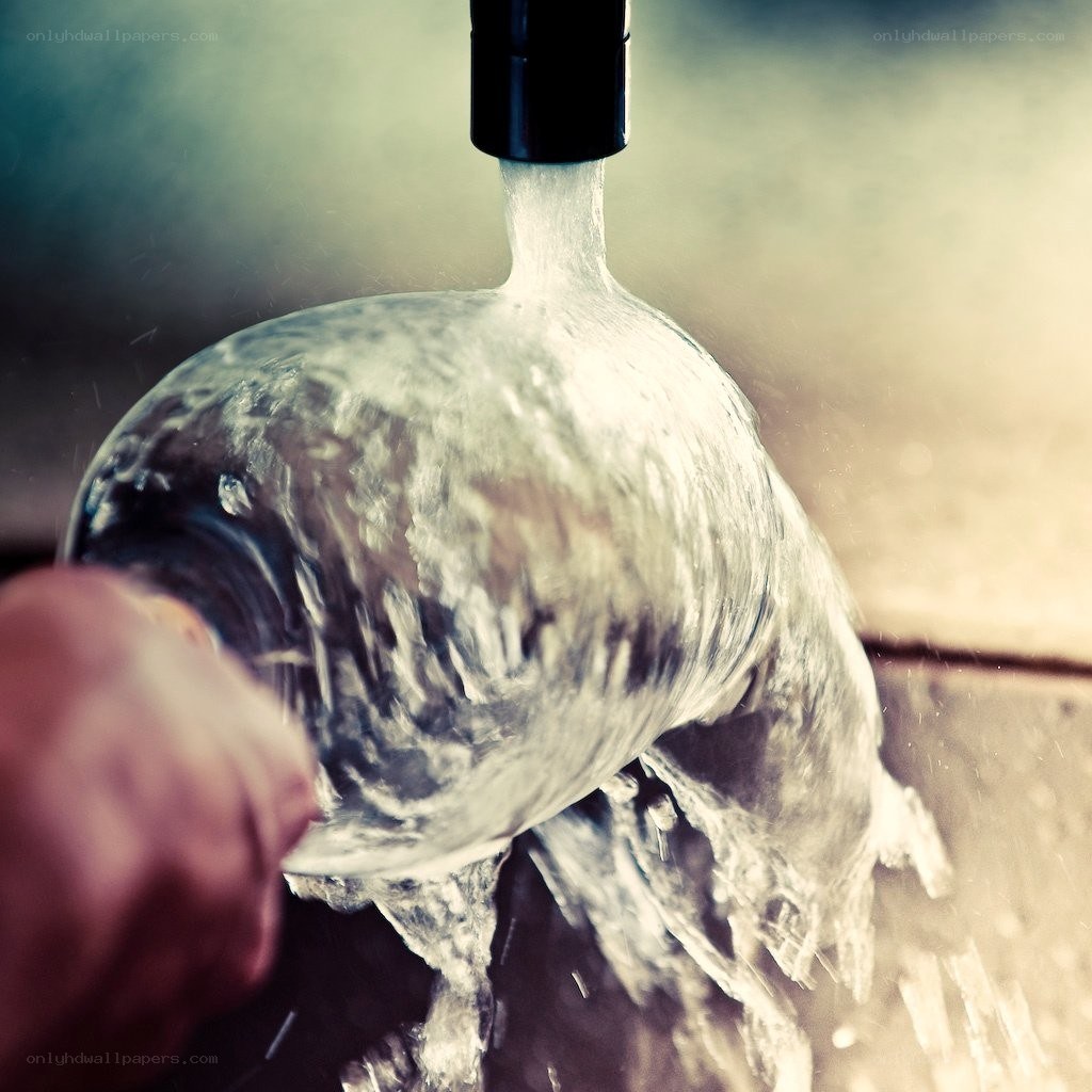 Water filling a glass bottle