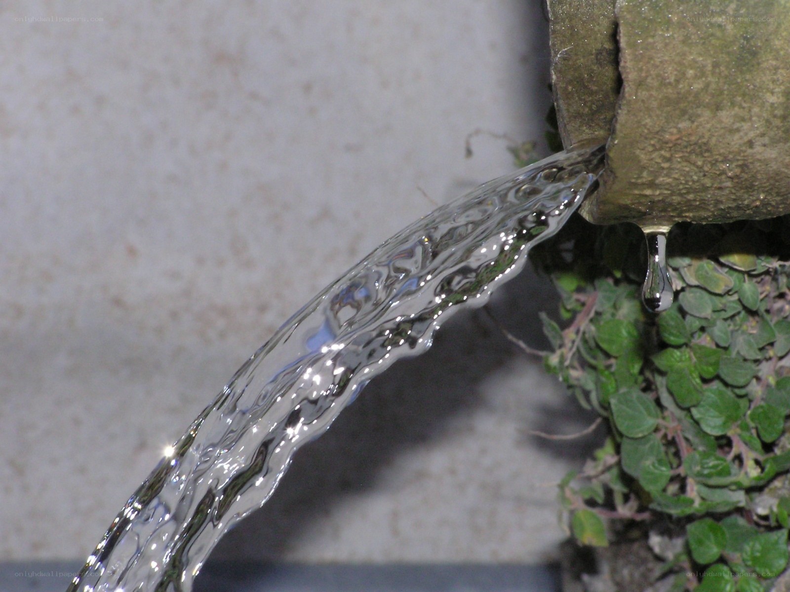 Water flowing from a stone spout