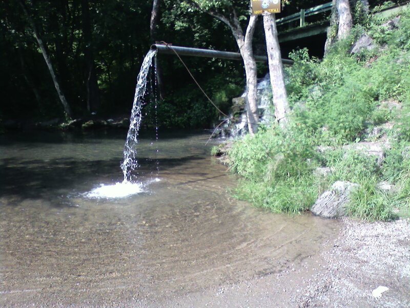 Water flowing from pipe into stream