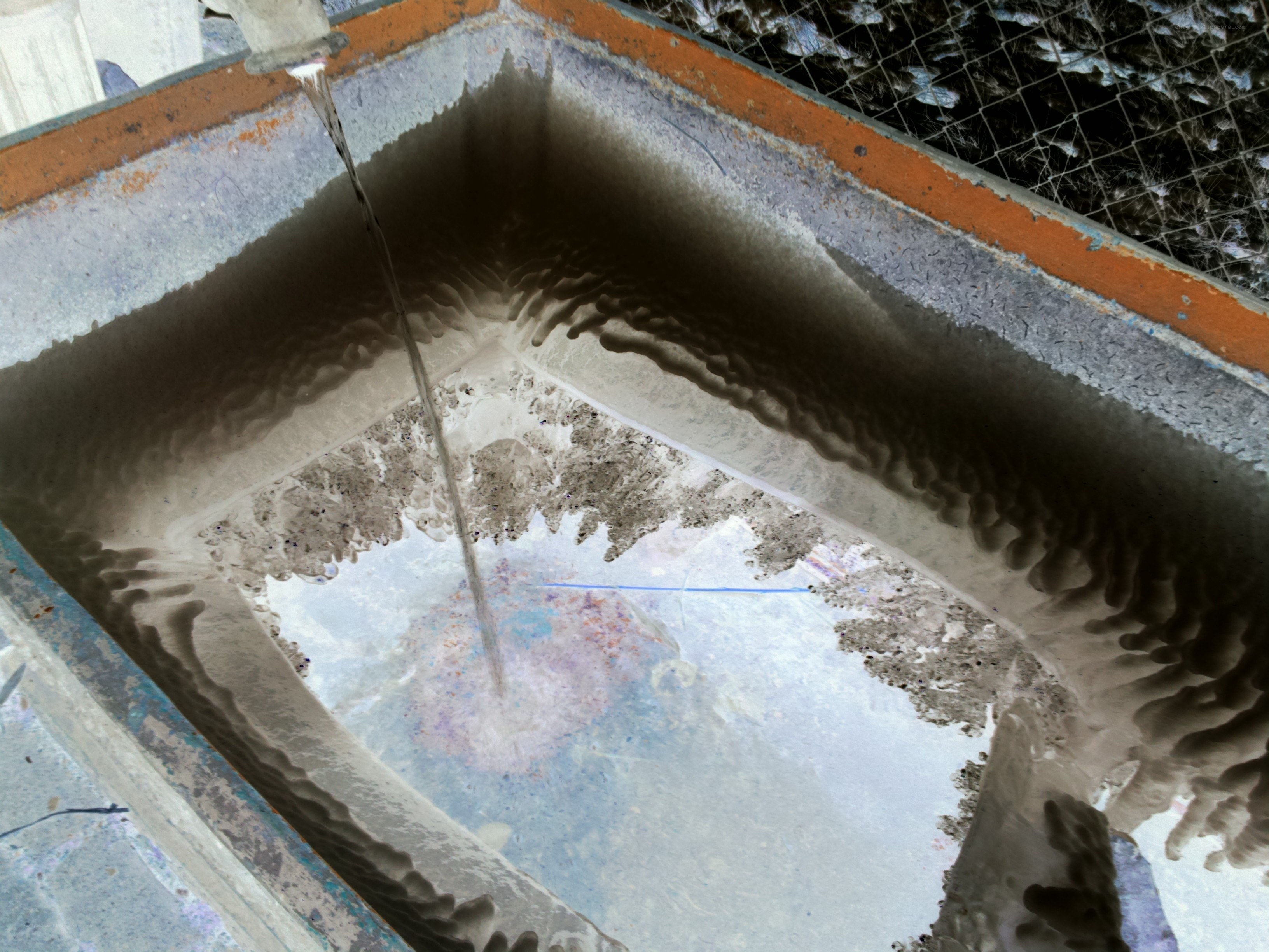 Water flowing into a concrete basin