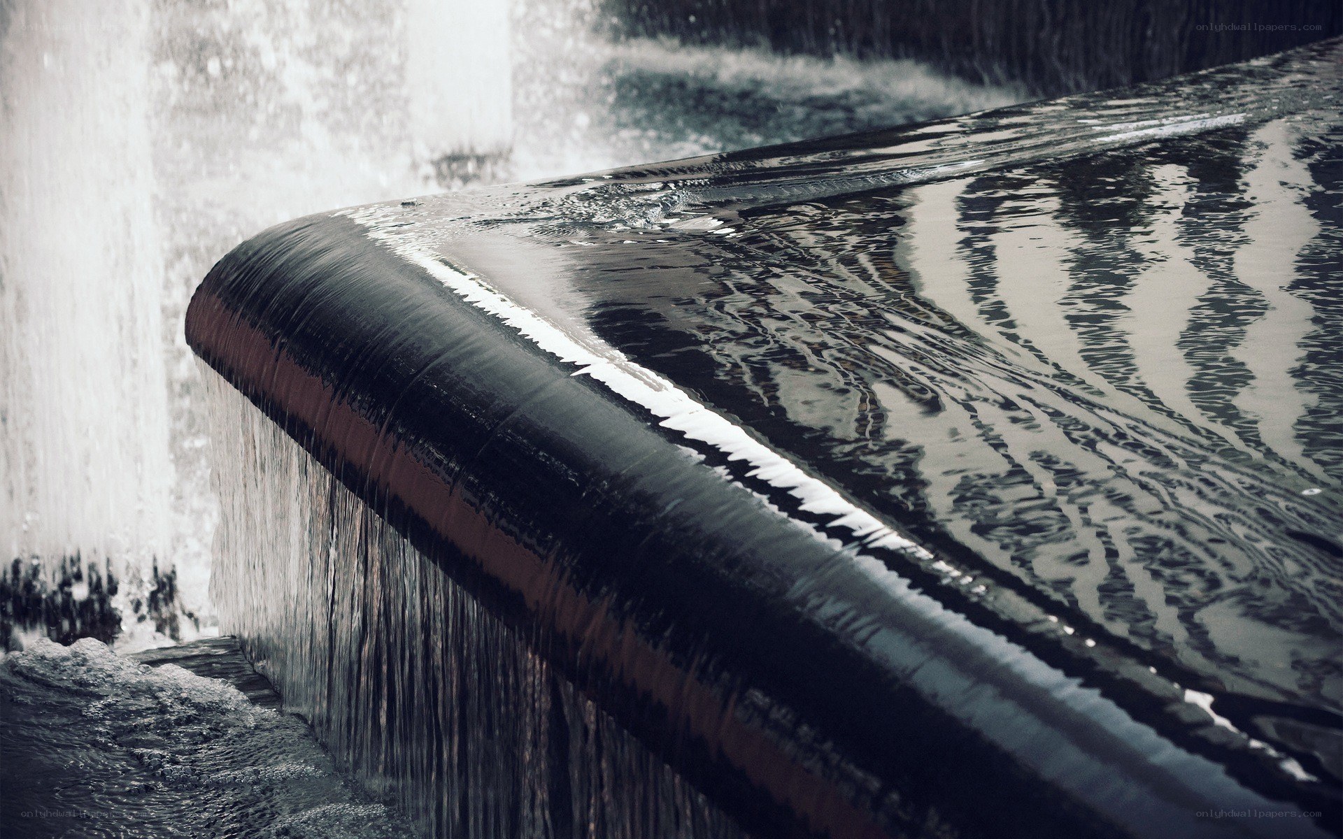 Water flowing over a curved edge