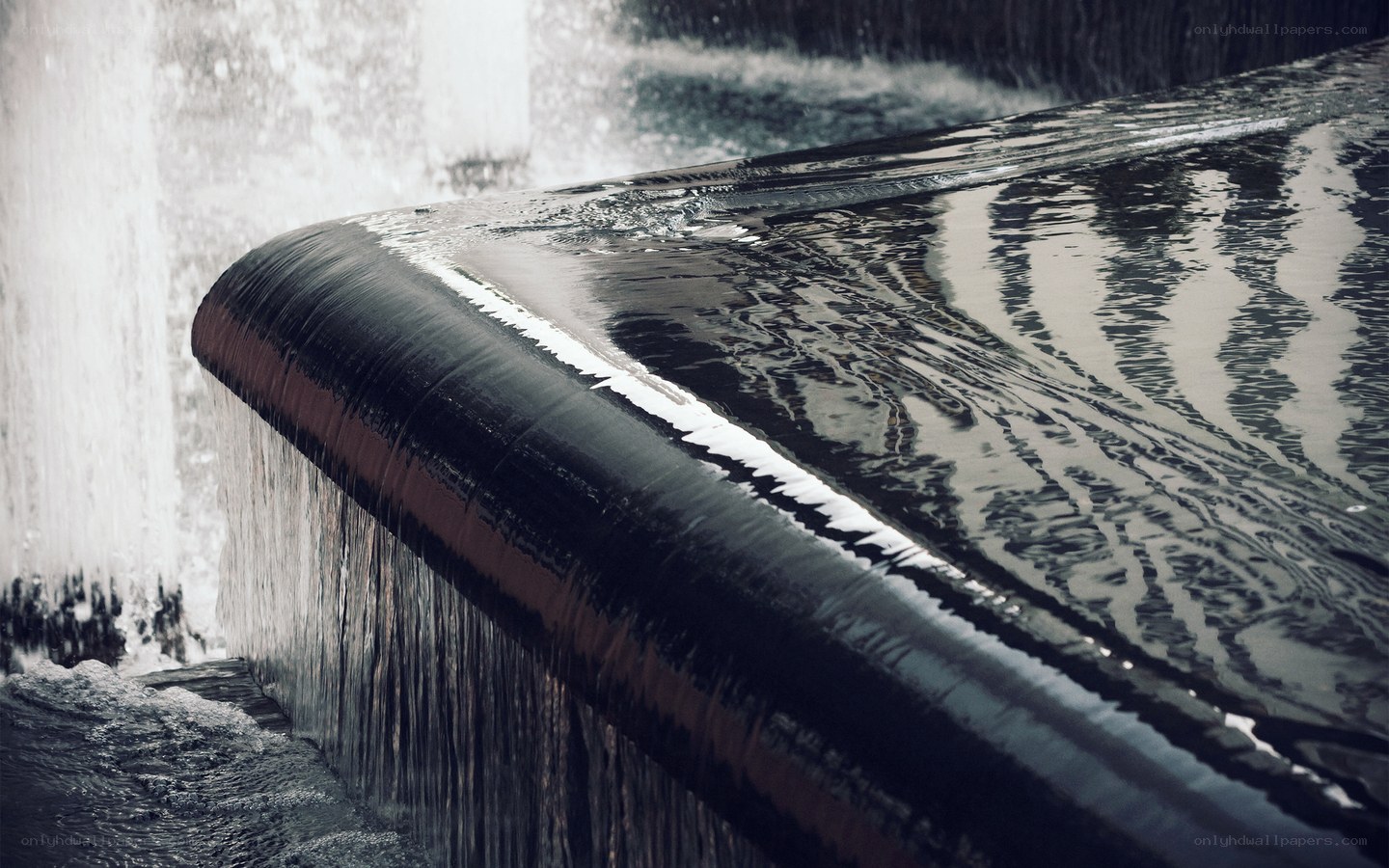 Water flowing over a curved edge