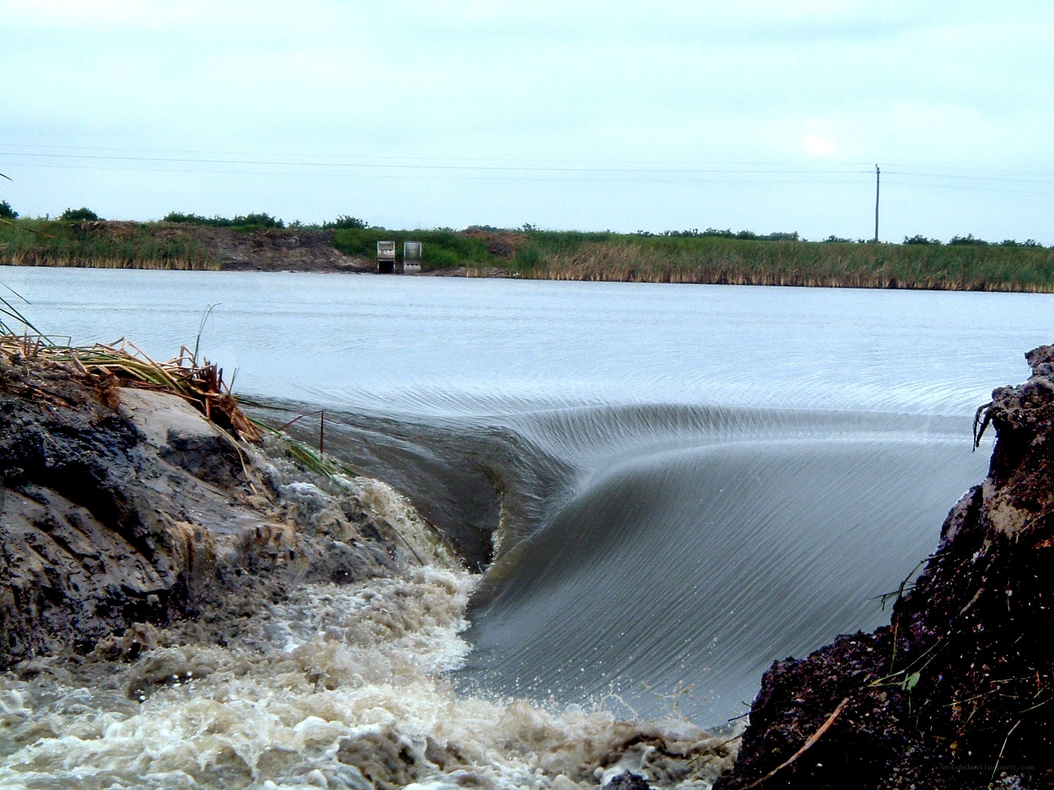 Water flowing over a small dam