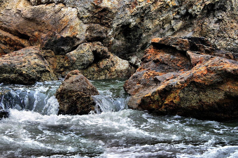 Water Flowing over Rocks — Brown