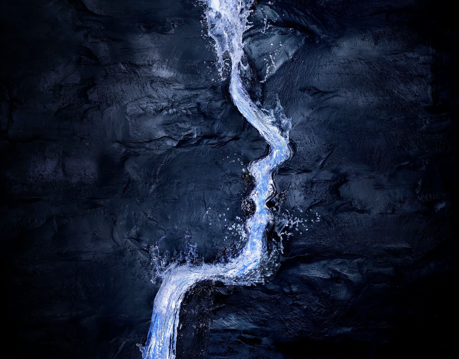 Water flowing through dark rock