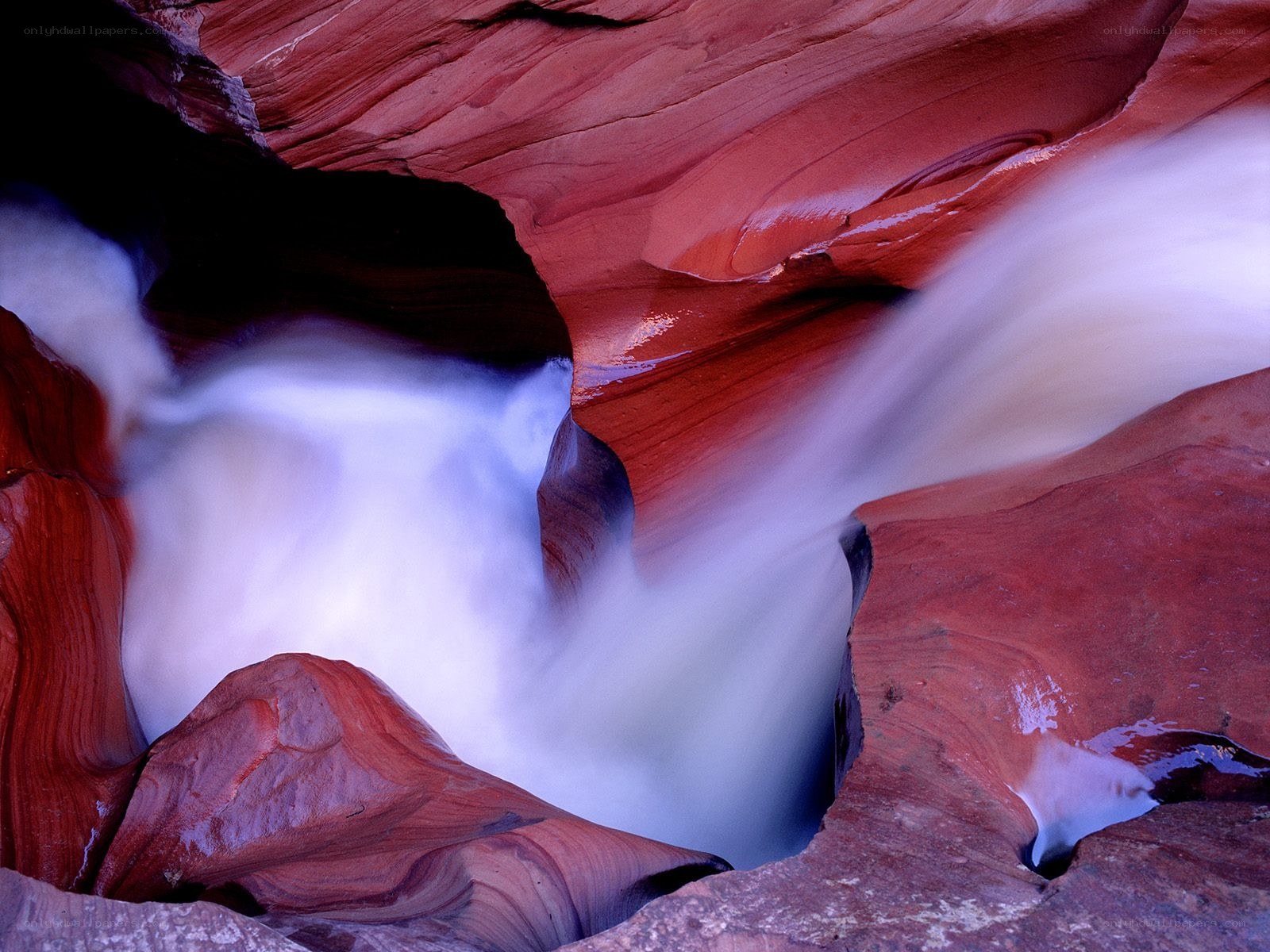 Water flowing through red canyon