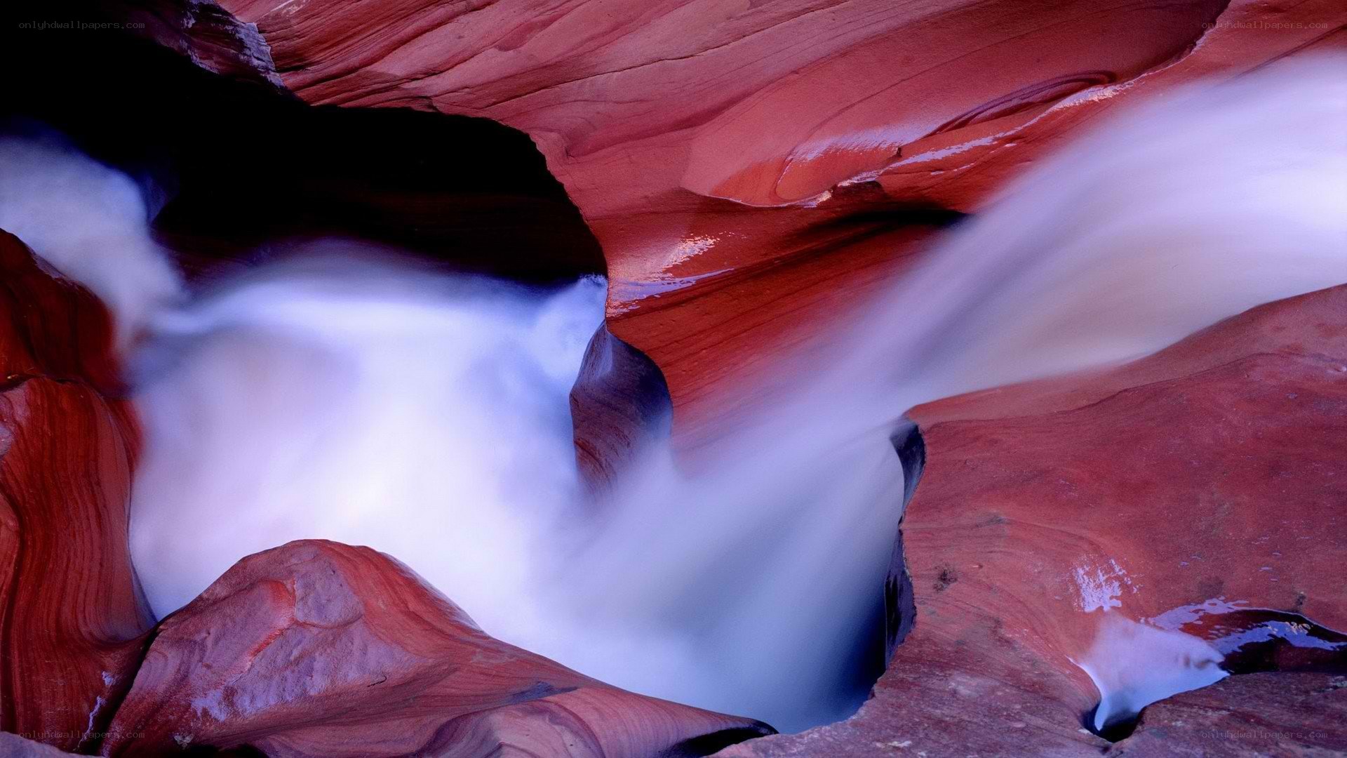 Water flowing through red rock canyon