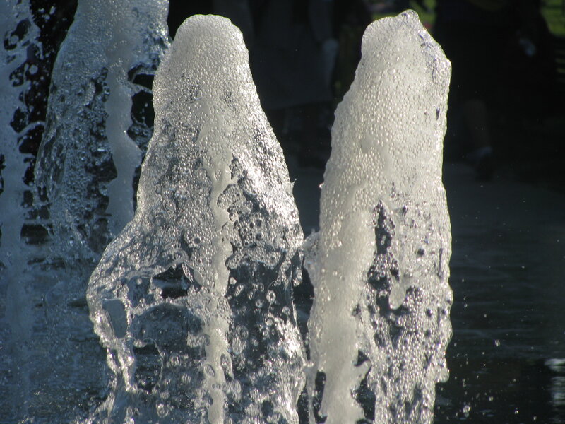 Water fountain jets in sunlight