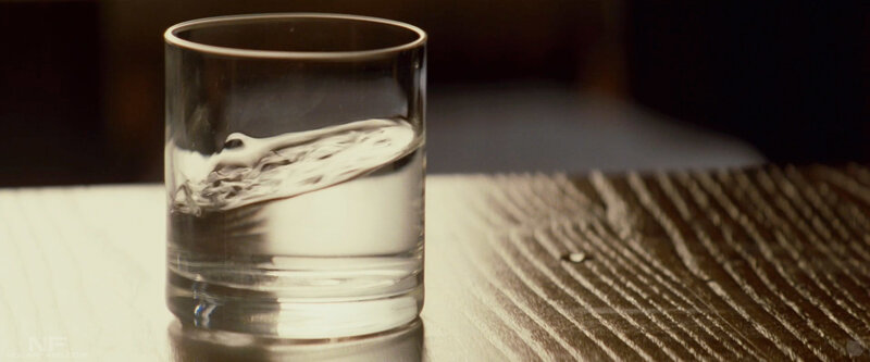 Water in a glass on wood