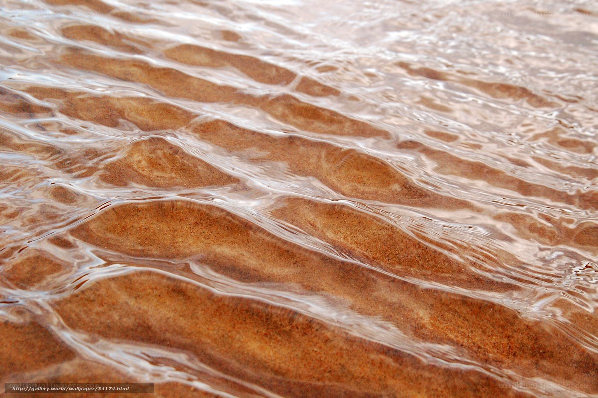 Water ripples on sandy beach