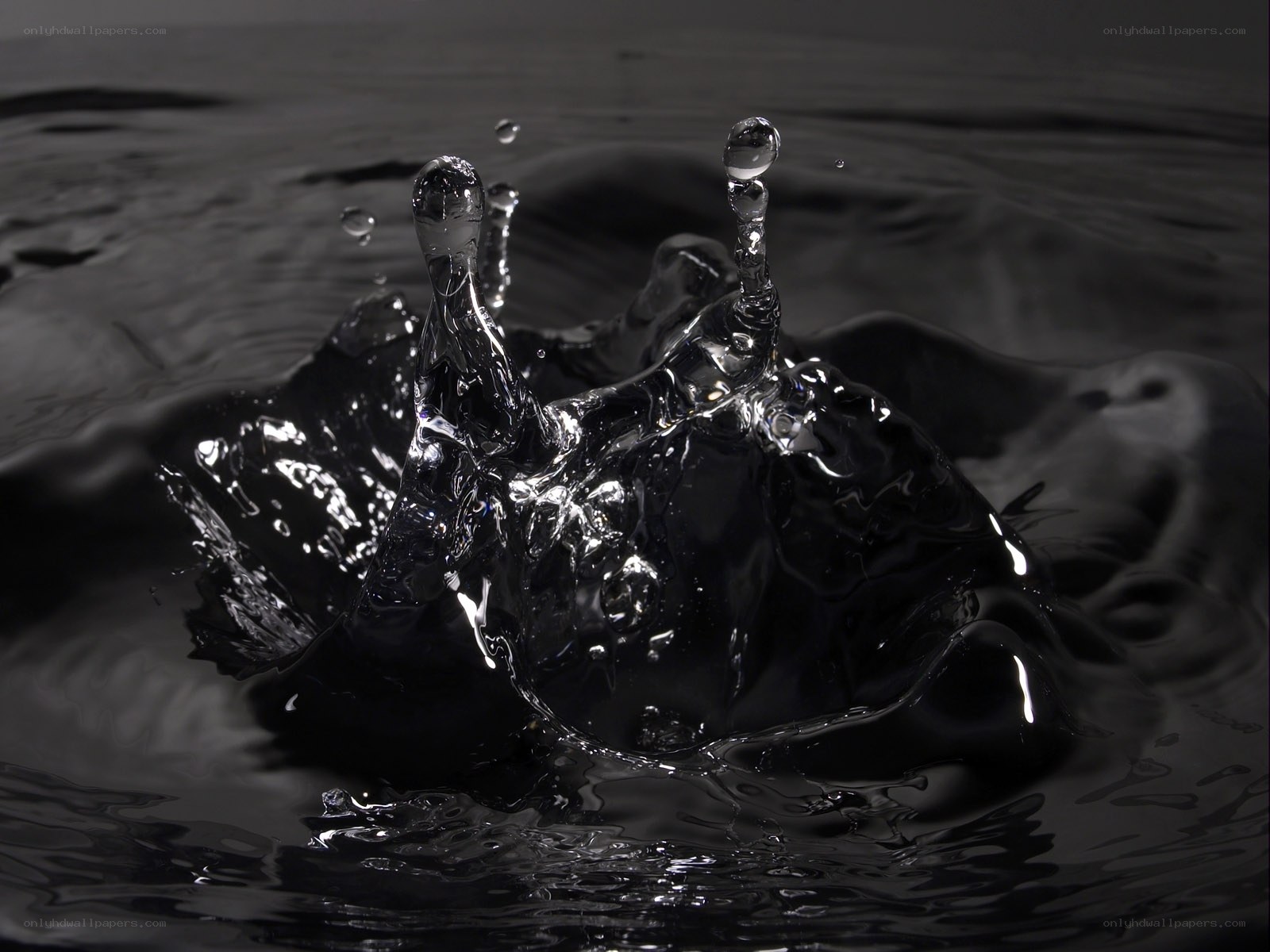 Water splash in dark liquid