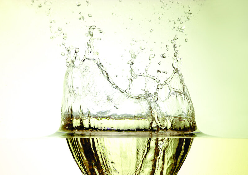 Water splash in golden liquid
