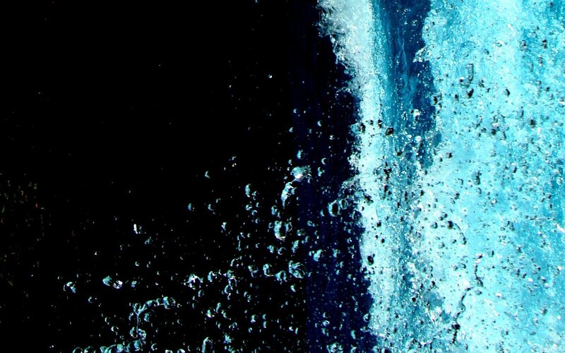 Water splashing against dark background