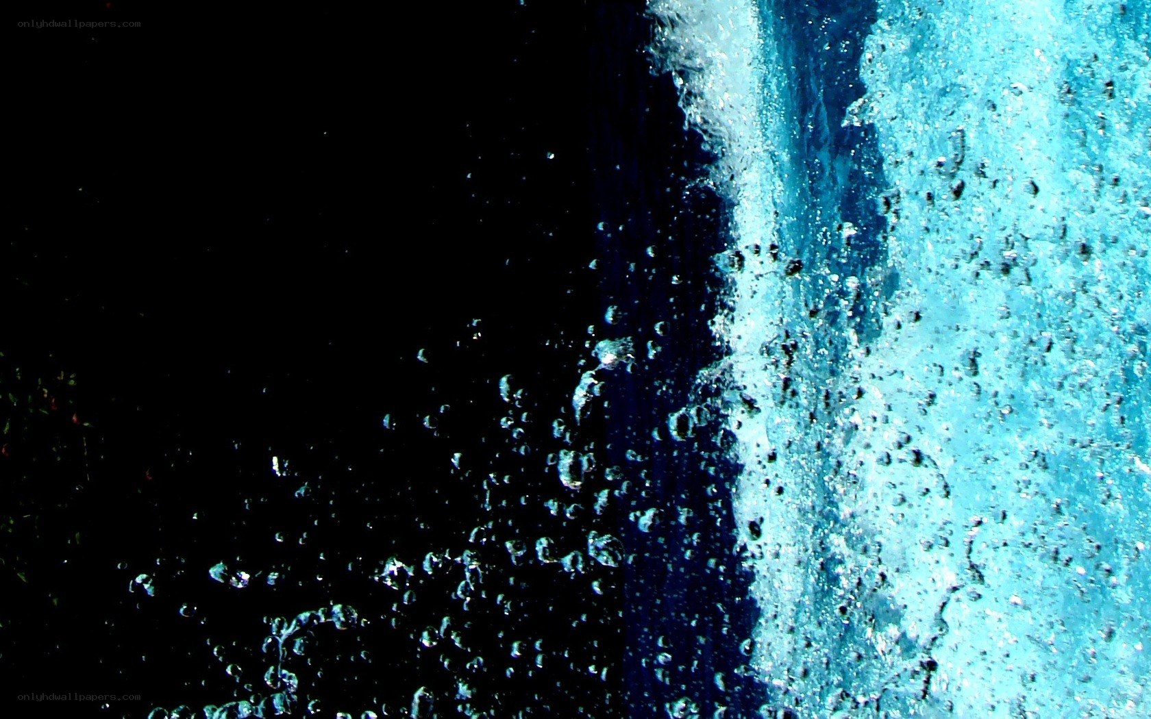 Water splashing against dark background