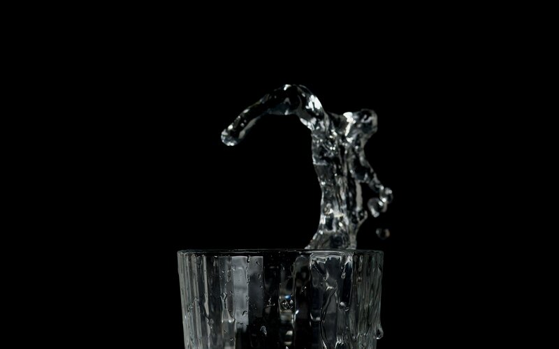 Water Splashing from Glass — Black