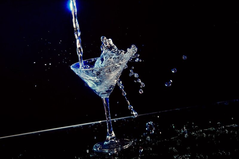 Water splashing into a martini glass