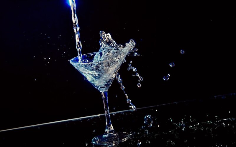 Water splashing into a martini glass
