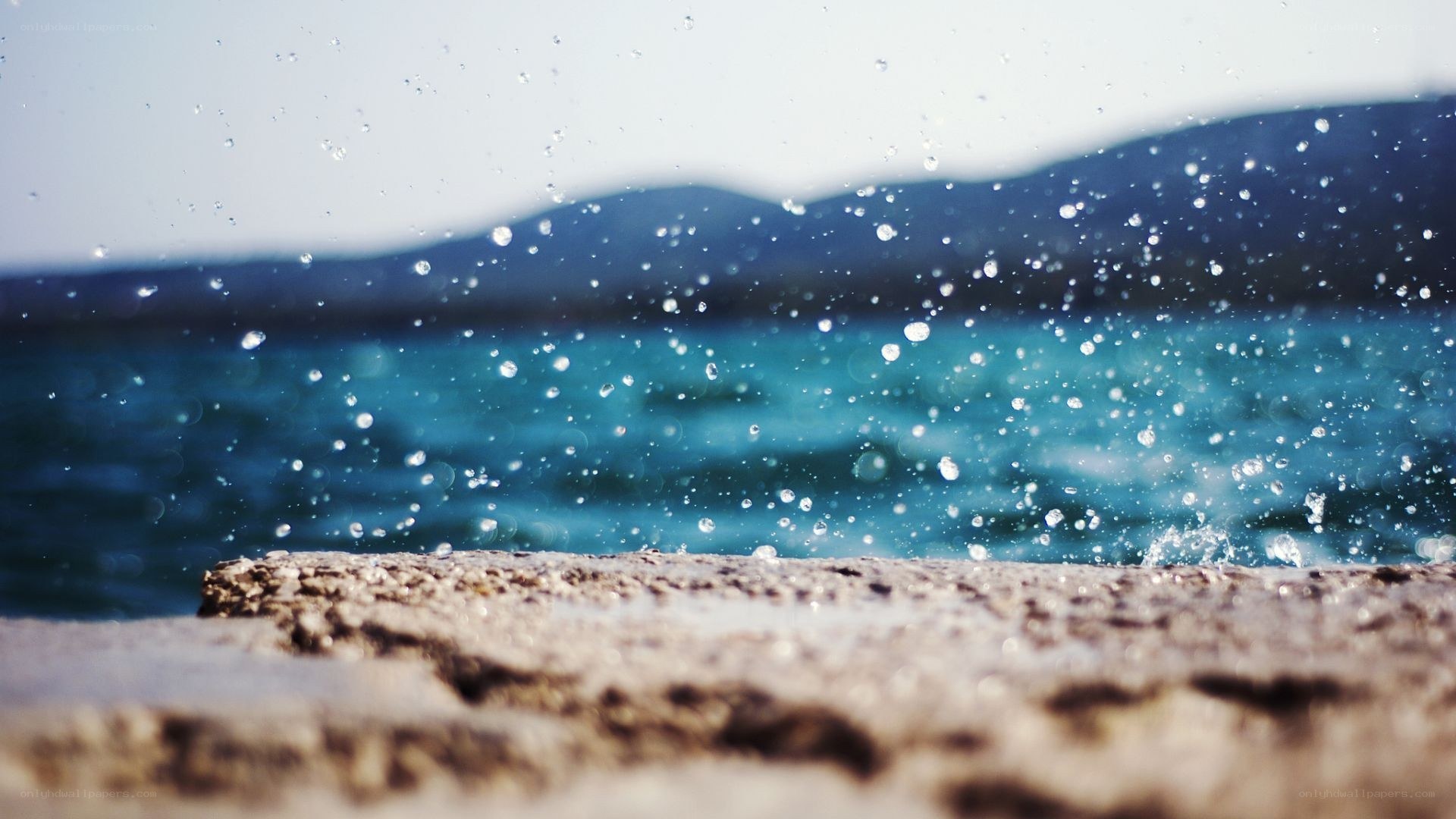 Water splashing on a stone wall