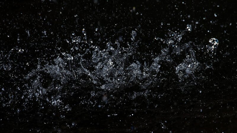 Water Splashing on Dark Surface — Black