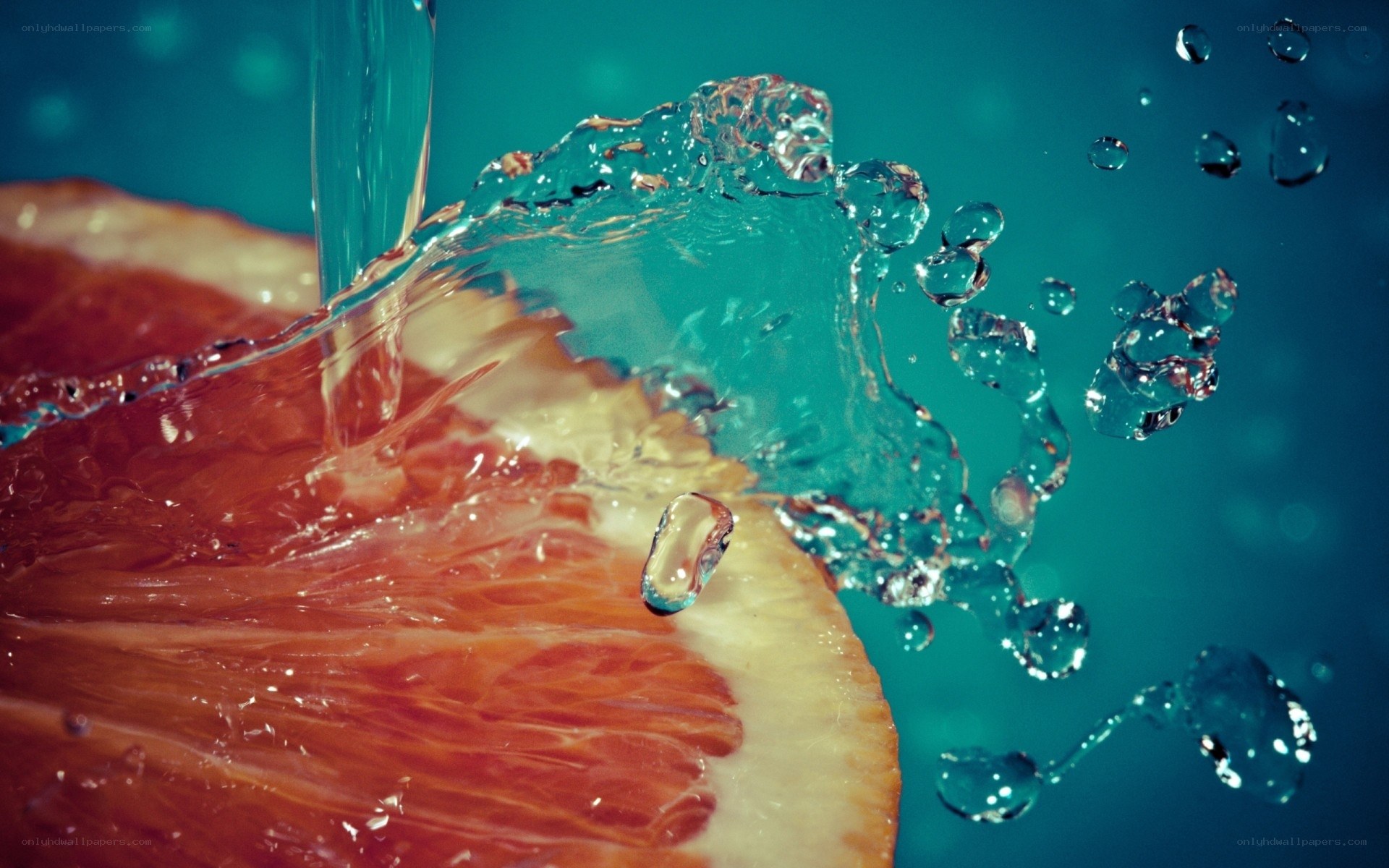 water splashing on grapefruit