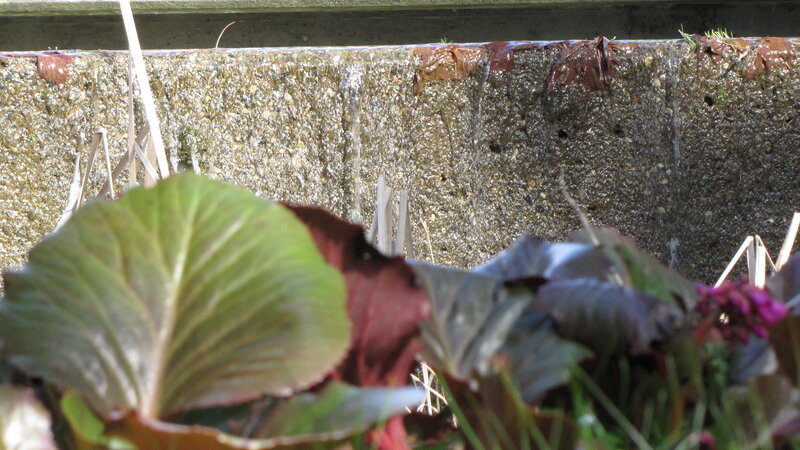 Water trickling over a stone wall