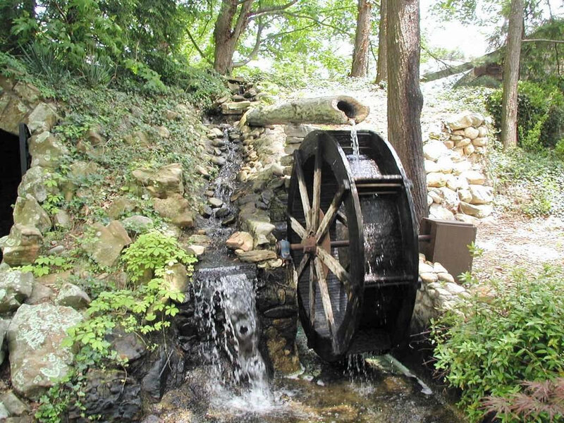 Water wheel in garden setting