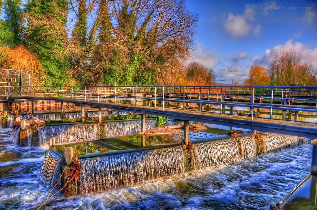 Waterfall and bridge at river lock