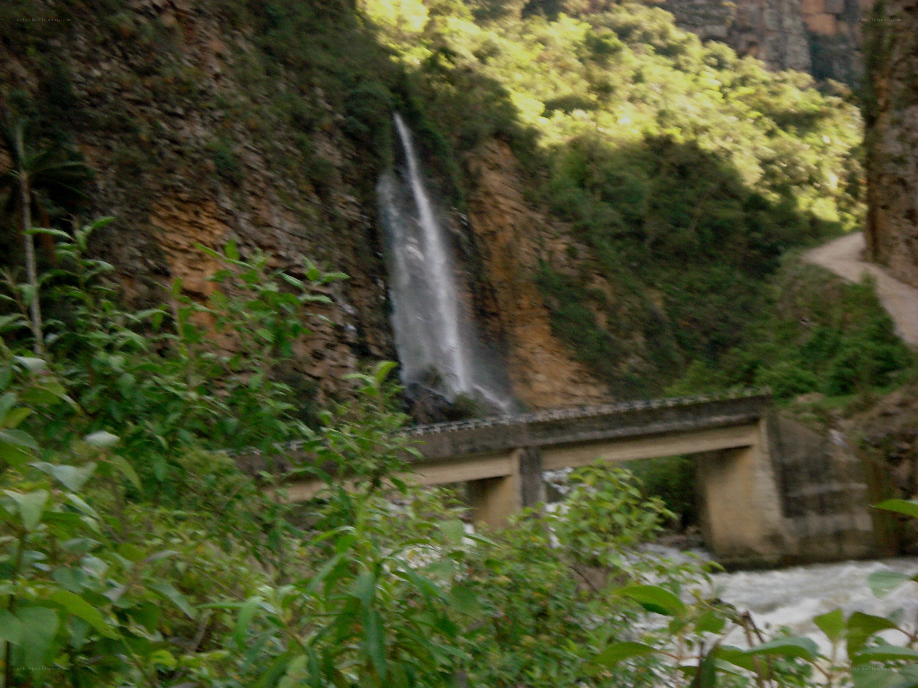 Waterfall and bridge in a canyon