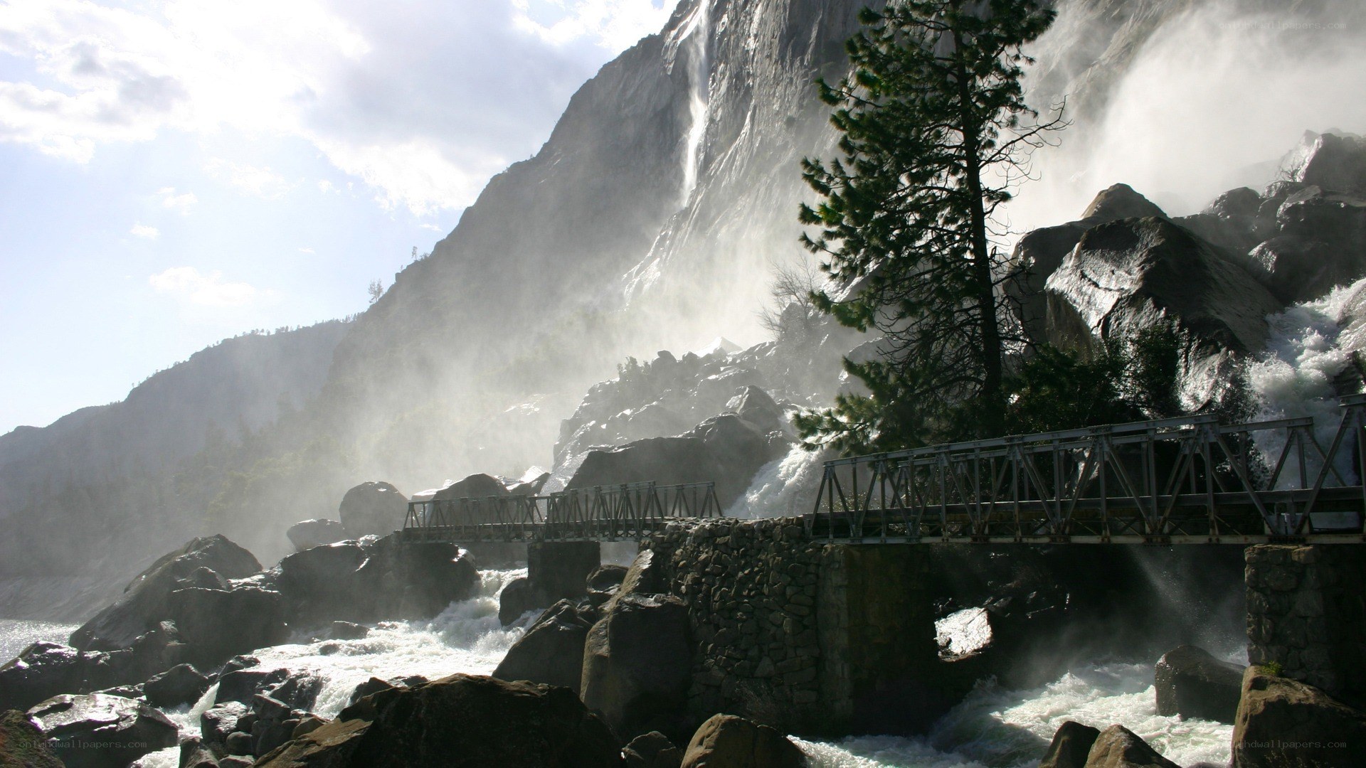 Waterfall and bridge in mountain valley