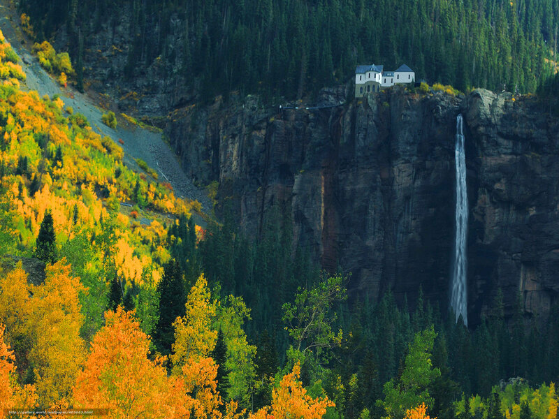 Waterfall and cliffside building