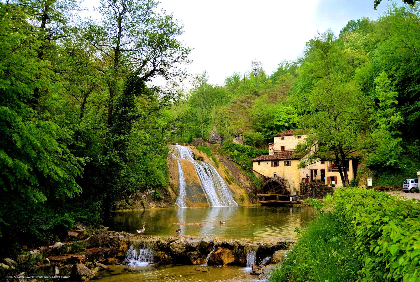 Waterfall and mill in green valley