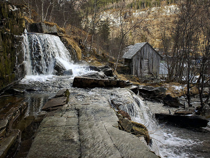 Waterfall and Wooden Cabin