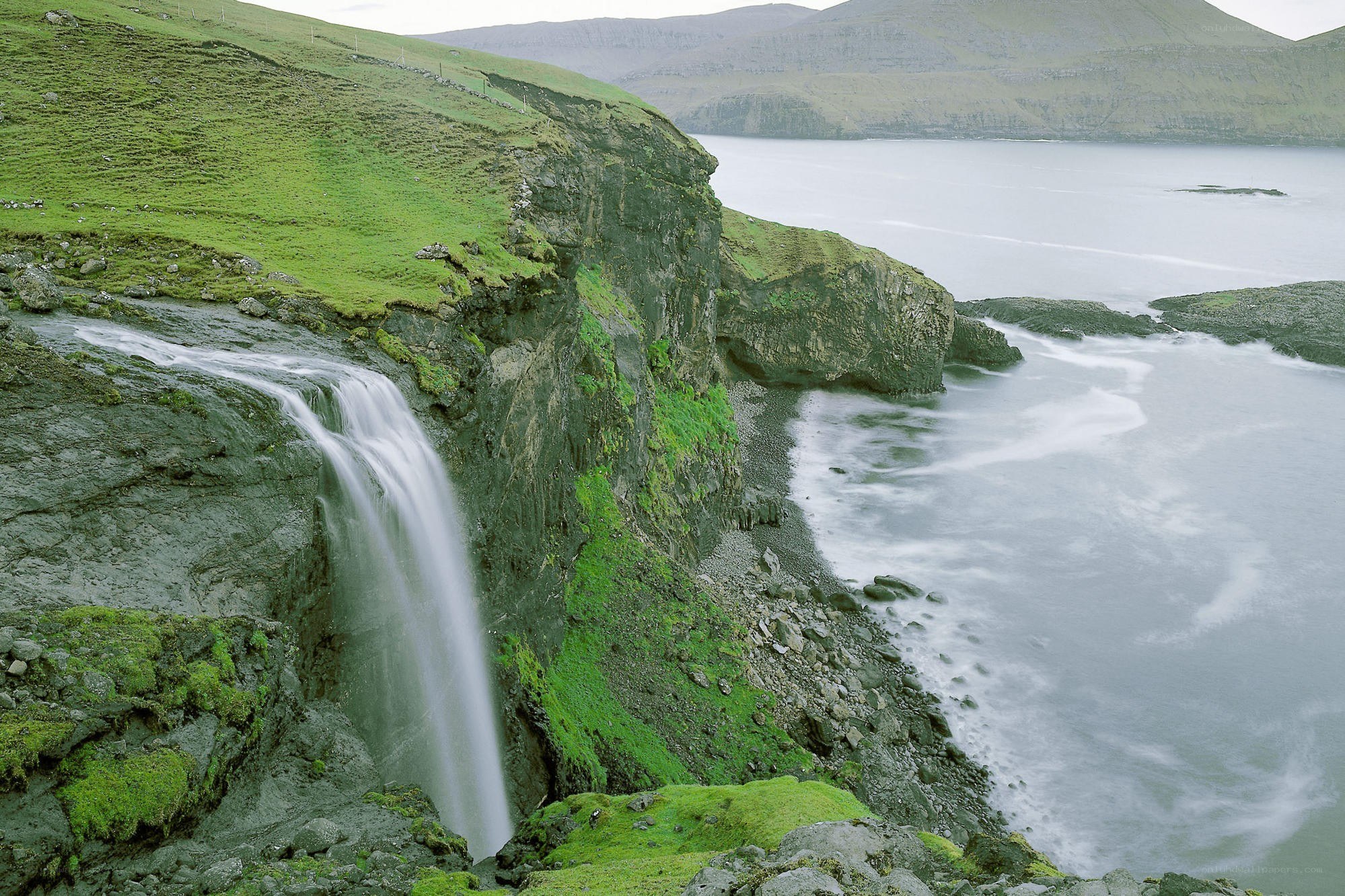 Waterfall at coastal cliff