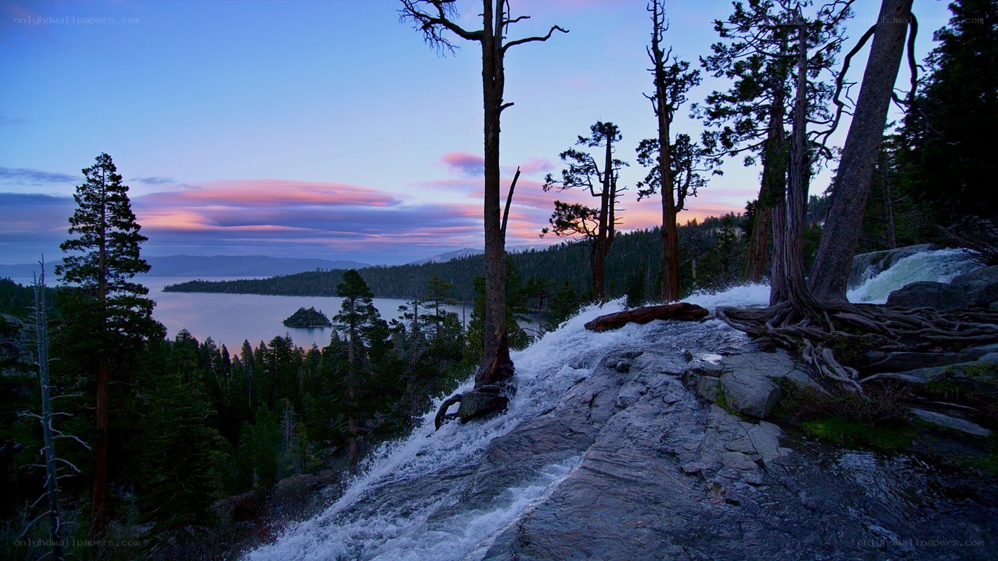 Waterfall at dusk by a lake