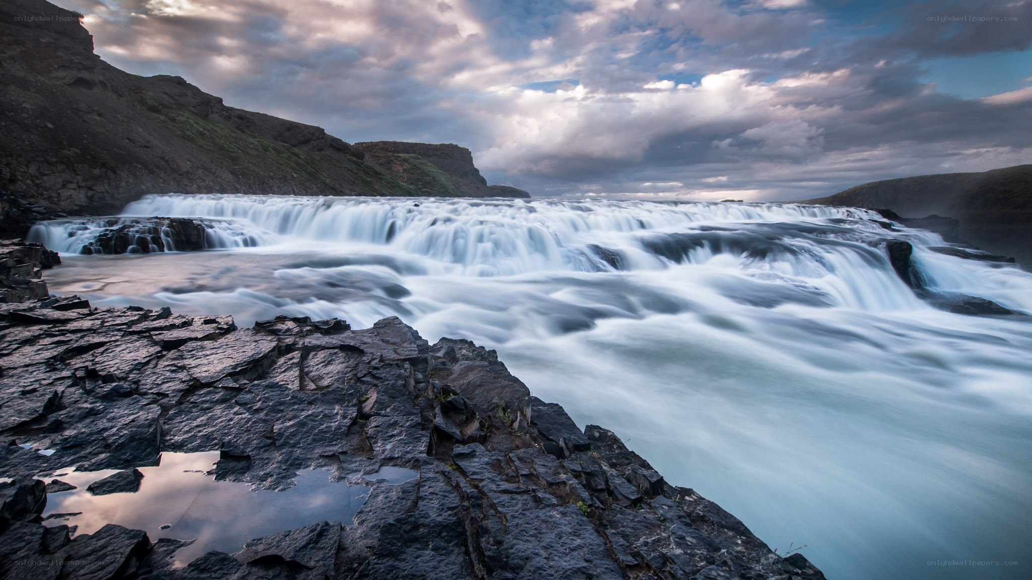 Waterfall at dusk with dramatic sky