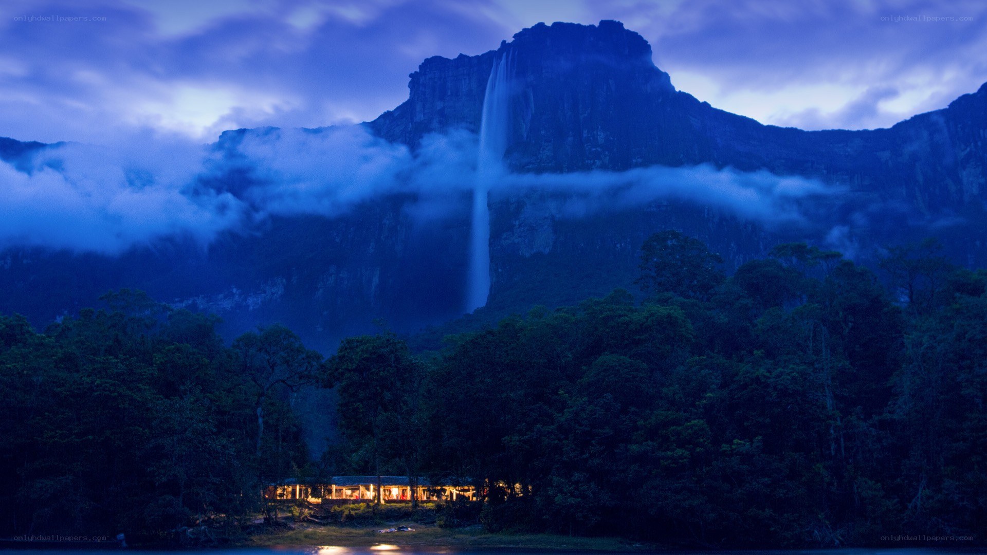 Waterfall at dusk with lodge