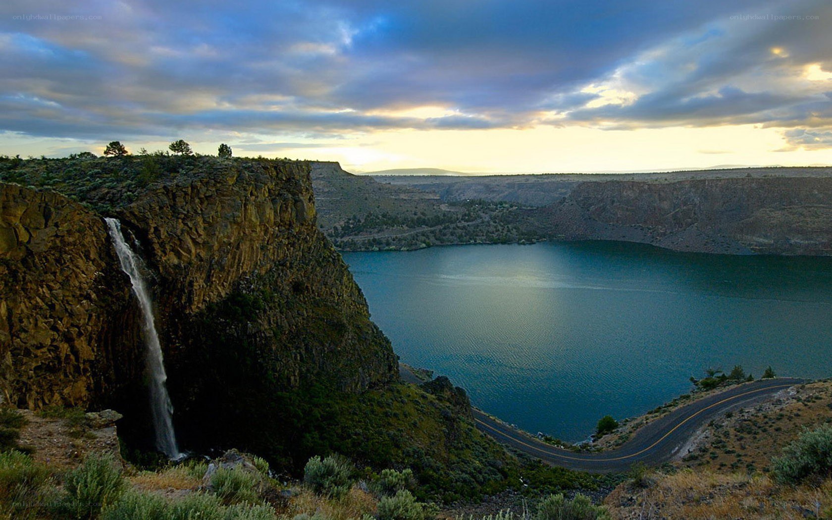 Waterfall at sunset by a lake