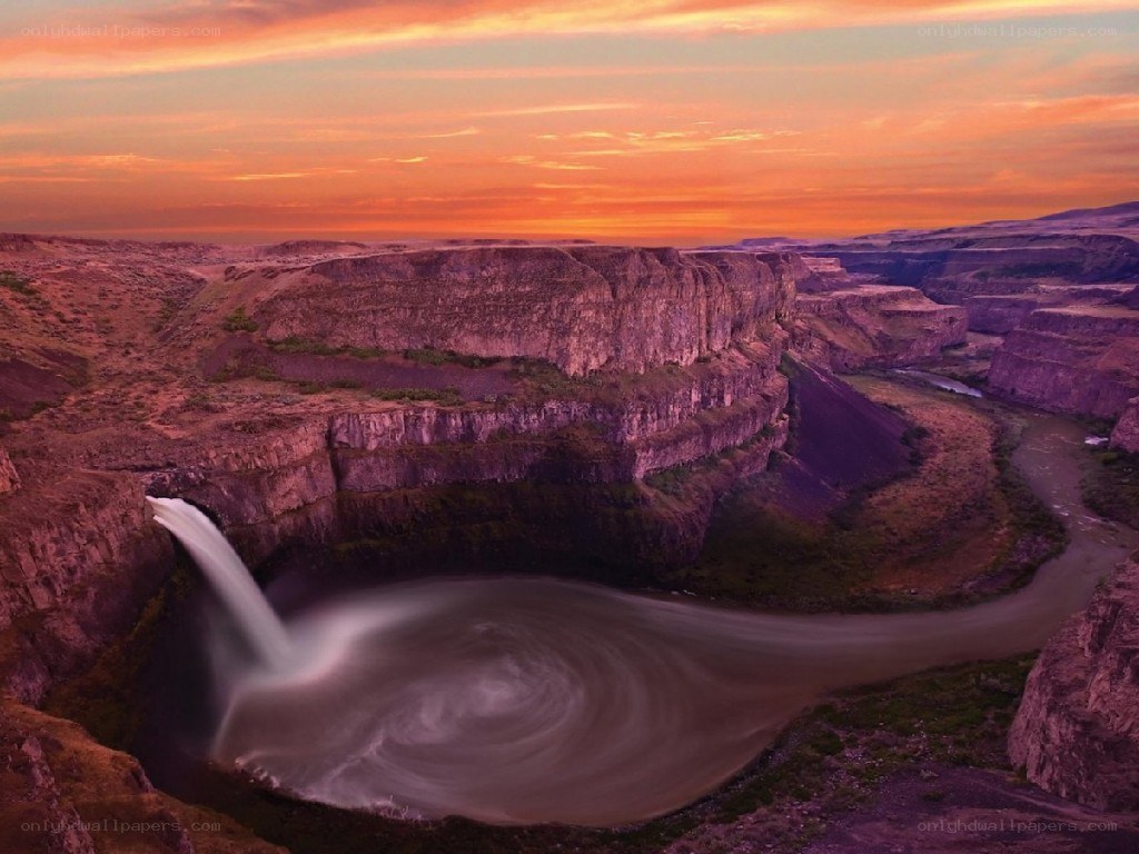 Waterfall at sunset in a canyon