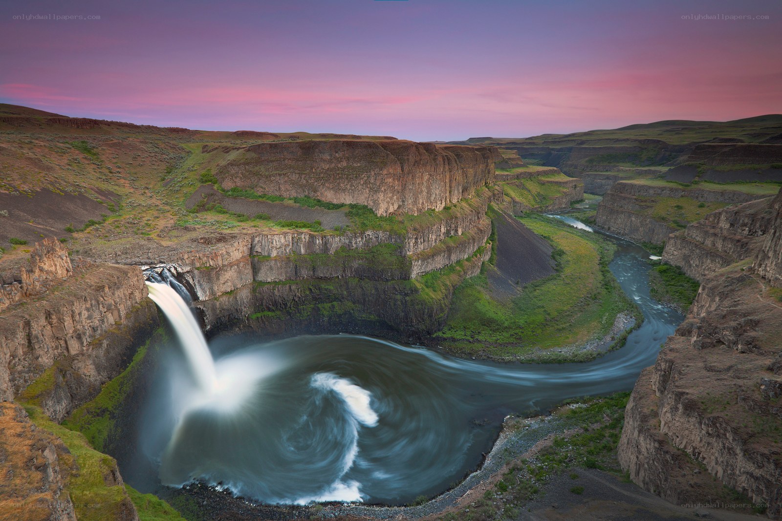 Waterfall at sunset in a canyon