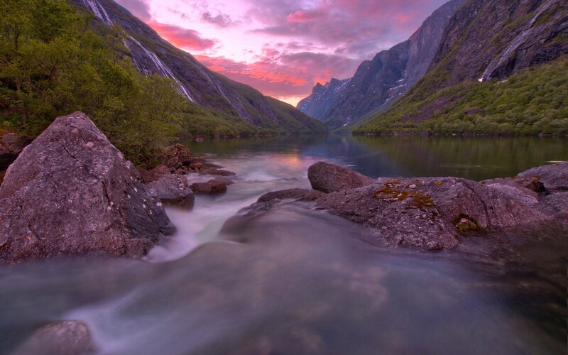 Waterfall at sunset in a fjord