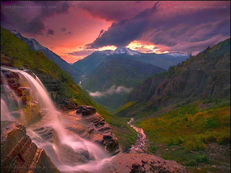 Waterfall at sunset in a mountain valley