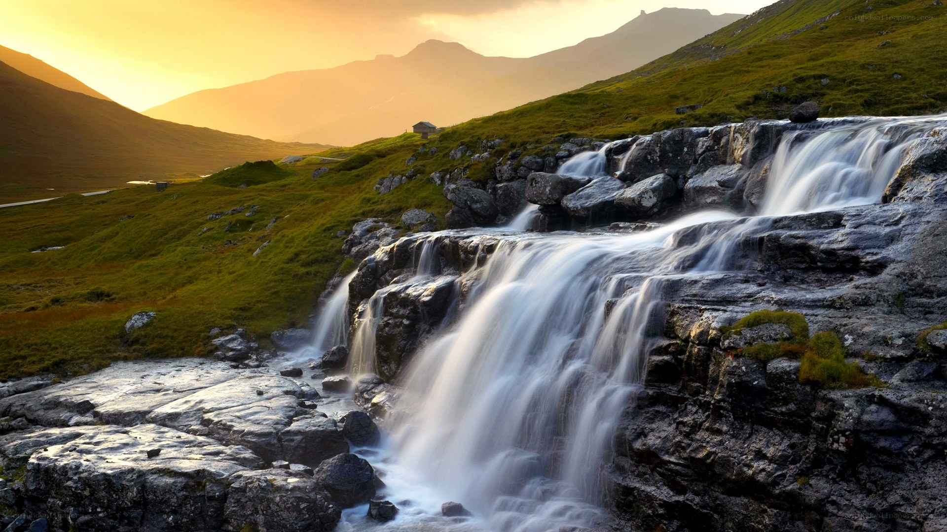 Waterfall at sunset in the mountains