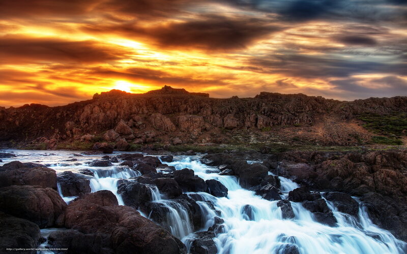 Waterfall at Sunset Over Rocks